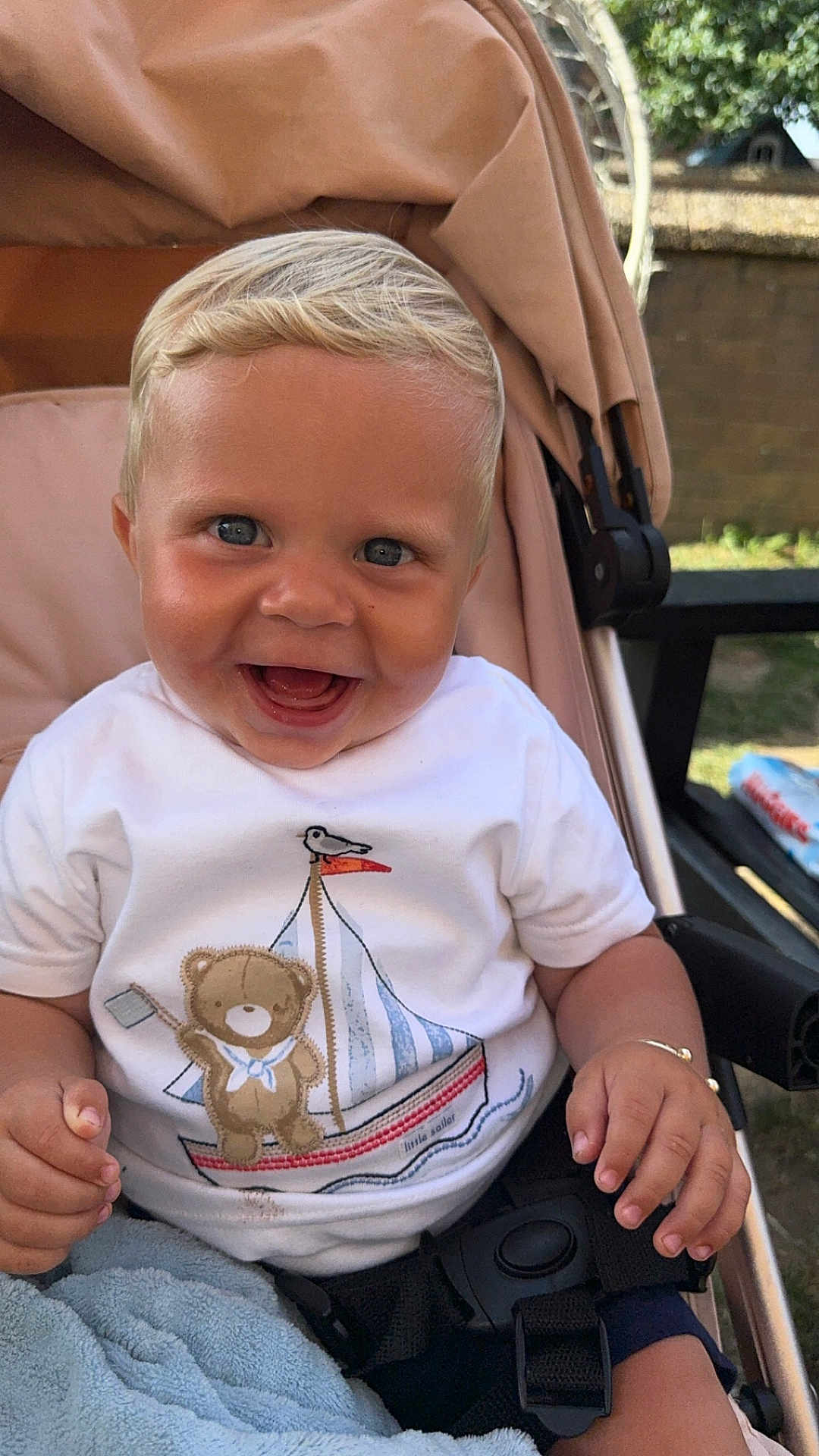 Beau-Harley joined the competition — help win amazing prizes! baby, child, smiling, stroller, white_shirt, teddy_bear, sailboat, blue_eyes, blanket, outdoor, sunlight, happy, infant, face, hand, clothing, seatbelt, portrait, cute, nature