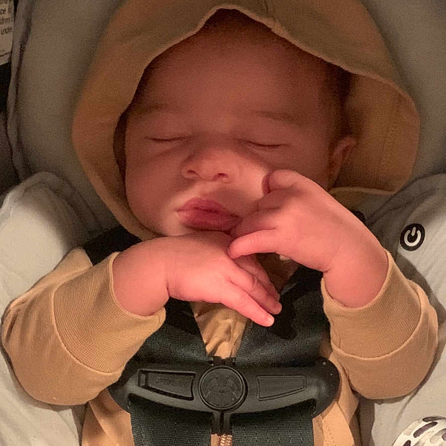 Kendrix is registered to the contest to win money with this photo: baby, bed, bodypart, bonnet, clothing, face, finger, furniture, hand, hat, head, hood, hoodie, knitwear, newborn, person, photography, portrait, sweater, sweatshirt