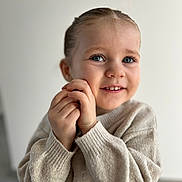 Aliya a rejoint le concours — aidez-le/la à gagner de superbes lots ! child, toddler, smiling, blue_eyes, sweater, hands, portrait, cute, indoor, happy, person, face, young_child, skin, long_sleeves, cozy, innocence, closeup, expression, light_background