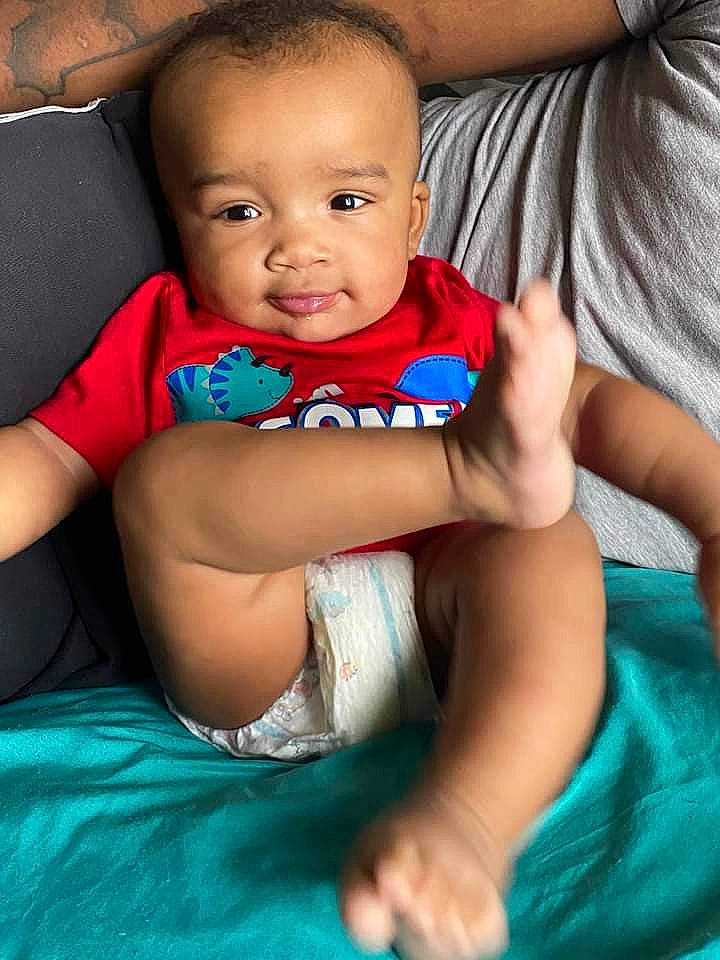 Kendrick joined the competition — help win amazing prizes! abdomen, azure, baby, baby_toddler_clothing, child, chin, comfort, couch, elbow, electric_blue, eye, flash_photography, fun, happy, iris, person, sitting, skin, smile, toddler