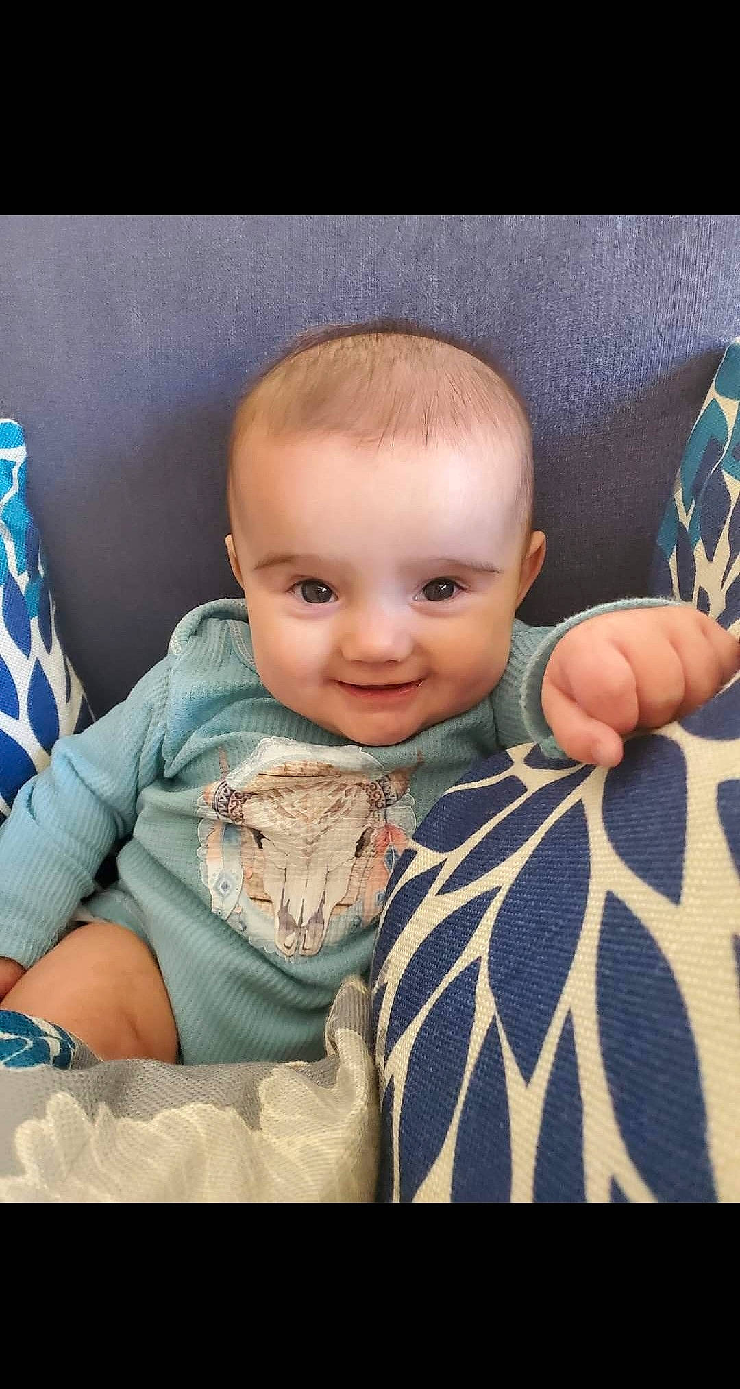 Aubrie is registered to the contest to win money with this photo: baby, baby_toddler_clothing, beauty, blue, cheek, child, comfort, flash_photography, gesture, hairstyle, hand, happy, joy, linens, pattern, person, sitting, skin, smile, thumb