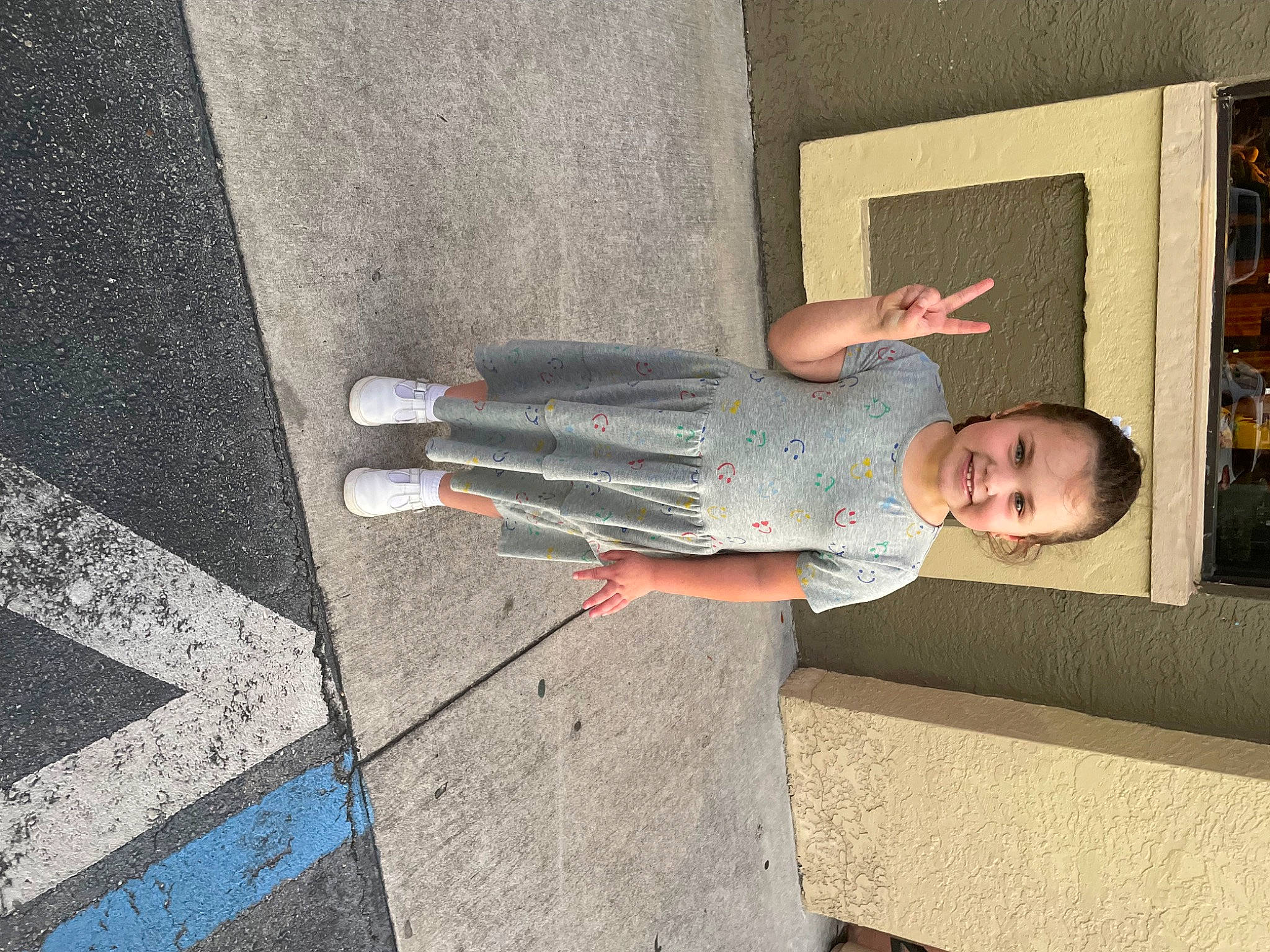 Scarlette joined the competition — help win amazing prizes! asphalt, cement, composite_material, concrete, elbow, floor, flooring, grey, human_leg, joy, pattern, person, road_surface, shadow, sidewalk, sitting, smile, t_shirt, toddler, walking_shoe