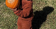 Easton joined the competition — help win amazing prizes! child, toddler, pumpkin, grass, outdoor, brown_clothing, holding, shadow, field, autumn, cute, person, young_child, nature, daylight, standing, pumpkin_patch, screen_screenshot, mobile_phone, apps