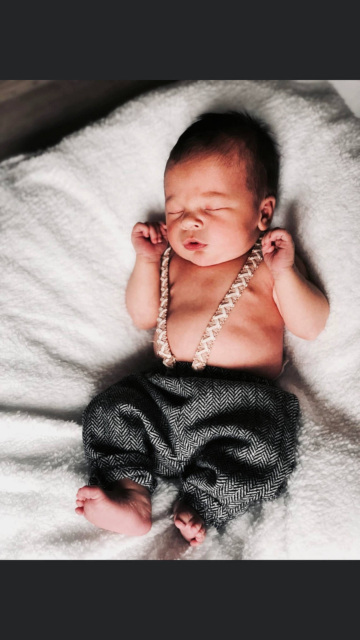 Jaxon is registered to the contest to win money with this photo: arm, baby, black_hair, cheek, child, facial_expression, fur, muscle, nose, person, photography, portrait_photography, sitting, skin, smile, toddler