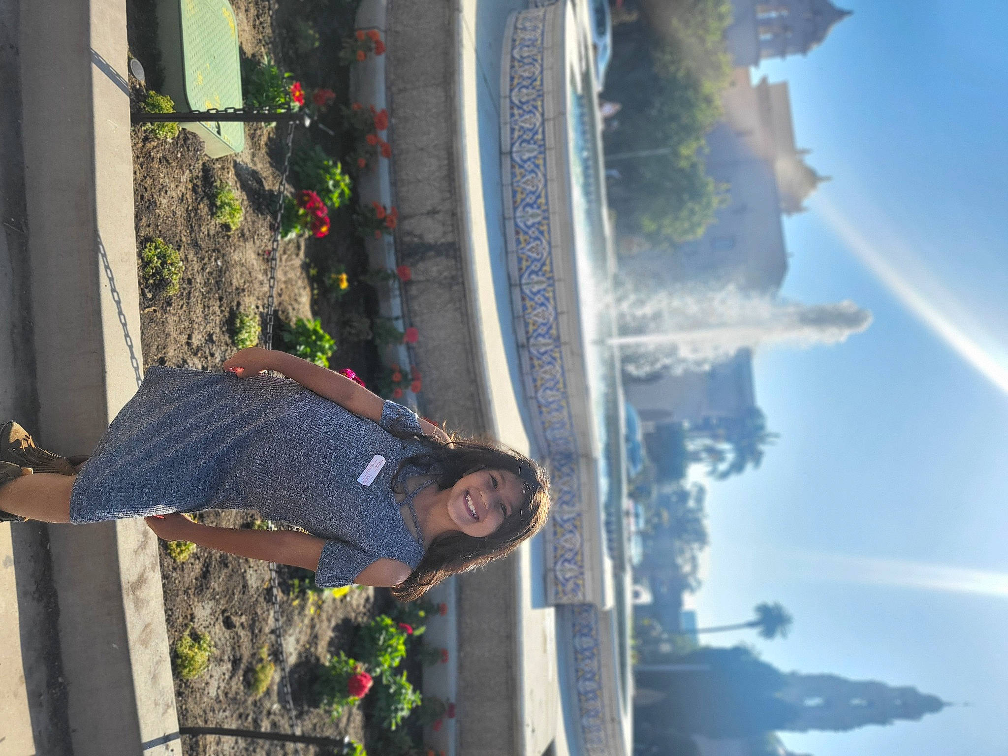 Alayna is registered to the contest to win money with this photo: arecales, building, city, cloud, daytime, facade, fun, headwear, joy, landscape, leaf, leisure, person, plant, pole, reflection, sky, smile, travel, tree