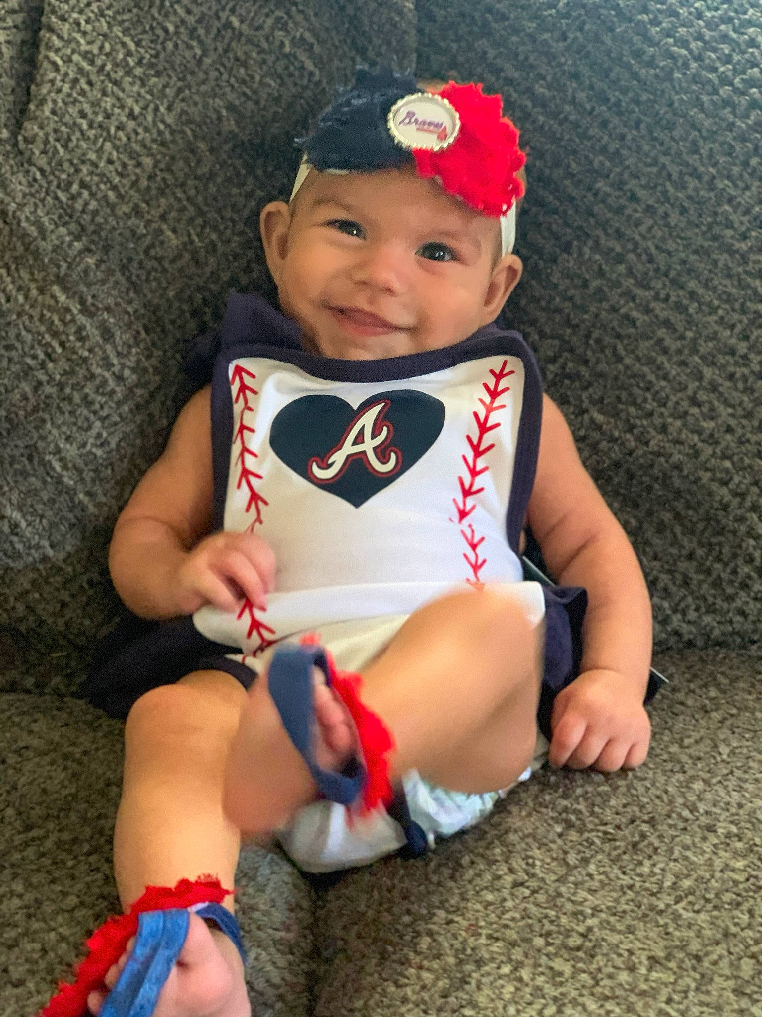 Henley is registered to the contest to win money with this photo: arm, baby, baby_products, baby_toddler_clothing, beanie, cap, child, clothing, costume, fashion_accessory, fictional_character, headgear, headwear, human_leg, joy, knee, leg, person, thigh, toddler