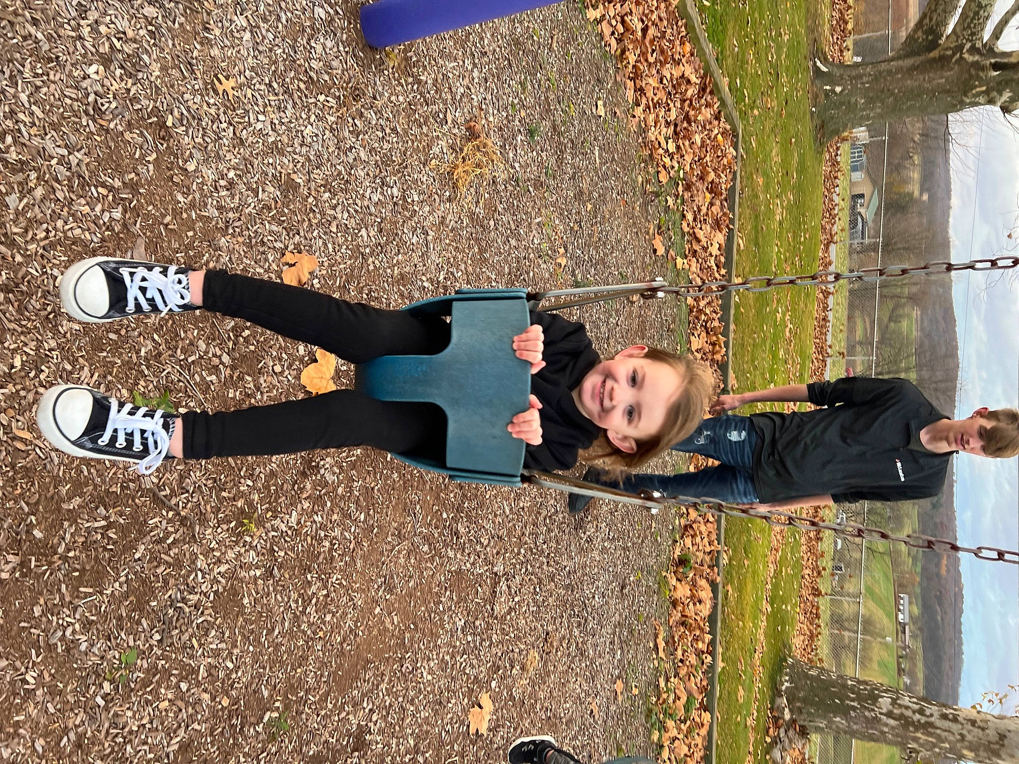 Oakley is registered to the contest to win money with this photo: asphalt, electric_blue, fun, grass, happy, human_leg, joy, leisure, outdoor_shoe, people_in_nature, person, recreation, shadow, smile, sock, soil, toddler, walking_shoe, wood