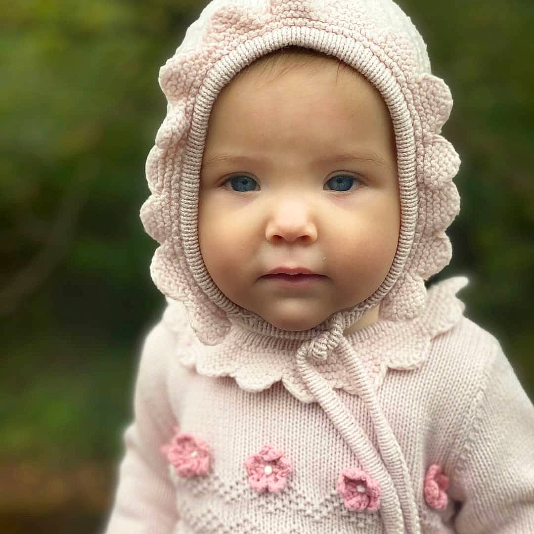 Anastasia joined the competition — help win amazing prizes! art, baby, cap, cheek, child, clothing, eyelash, facial_expression, grass, happy, hat, headwear, knit_cap, lip, outerwear, person, petal, pink, skin, toddler