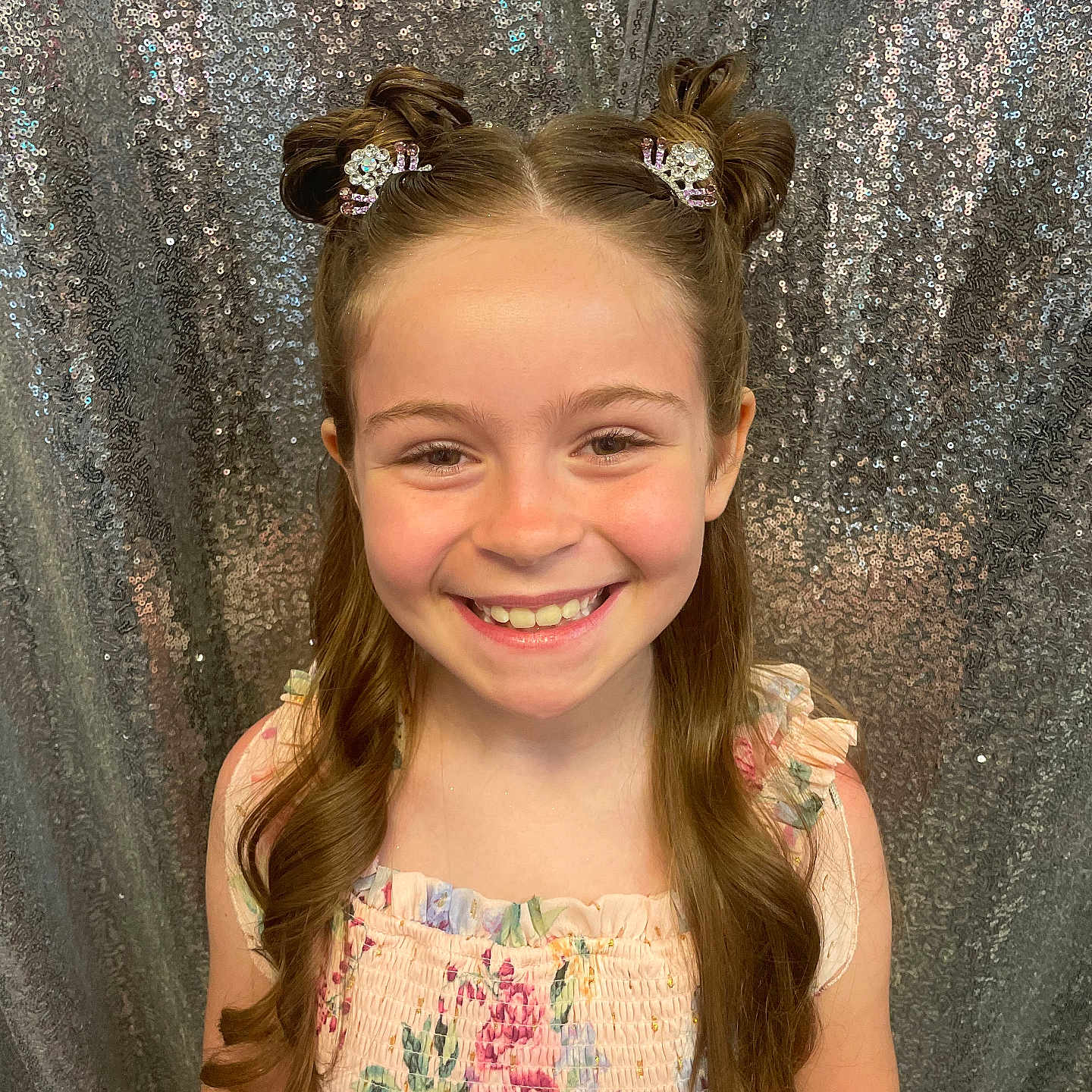 Joanie joined the competition — help win amazing prizes! celebration, child, cute, dress, face, fashion, floral, fun, girl, hair_buns, hair_clips, happy, head, long_hair, pattern, photography, portrait, sequin_backdrop, smiling, studio