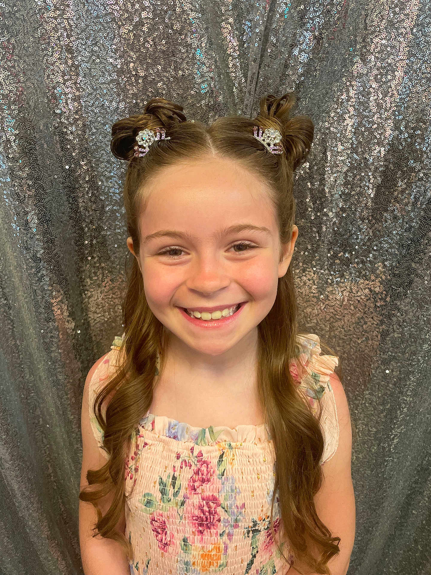 Joanie joined the competition — help win amazing prizes! child, girl, smiling, hair_clips, hair_buns, long_hair, dress, floral, pattern, sequin_backdrop, portrait, happy, cute, fashion, studio, photography, face, head, fun, celebration
