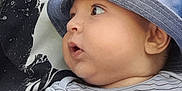 Nathan participe au concours pour gagner de l'argent avec cette photo : baby, child, hat, blue_hat, striped_shirt, cartoon, raccoon, face, profile, curious, cute, infant, person, portrait, clothing, pattern, black_and_white, close_up, young_child, casual