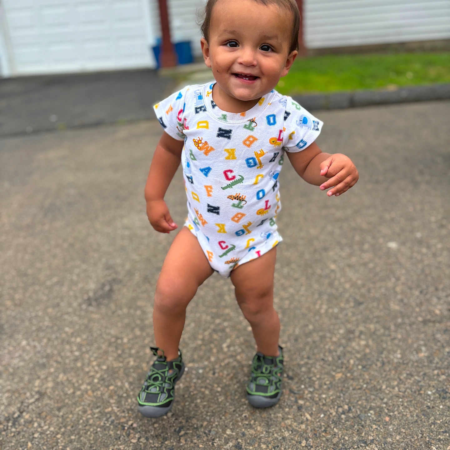 Lorenzo is registered to the contest to win money with this photo: baby, bodypart, city, clothing, face, finger, footwear, hand, happy, head, pants, person, photography, portrait, road, shoe, shorts, street, urban, walking