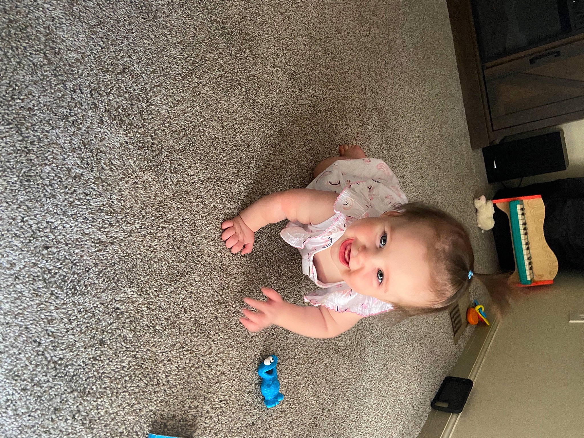 Braelynn is registered to the contest to win money with this photo: arm, baby, baby_products, baby_toddler_clothing, baby_toys, child, comfort, floor, flooring, fun, grass, home_appliance, joy, person, play, room, toddler, wood