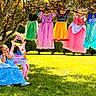 child, toddler, princess_dress, blue_dress, pink_vanity, mirror, grass, tree, sunlight, outdoor, play, costume, dress_up, happy, smile, nature, greenery, clothing, cute, imaginative_play