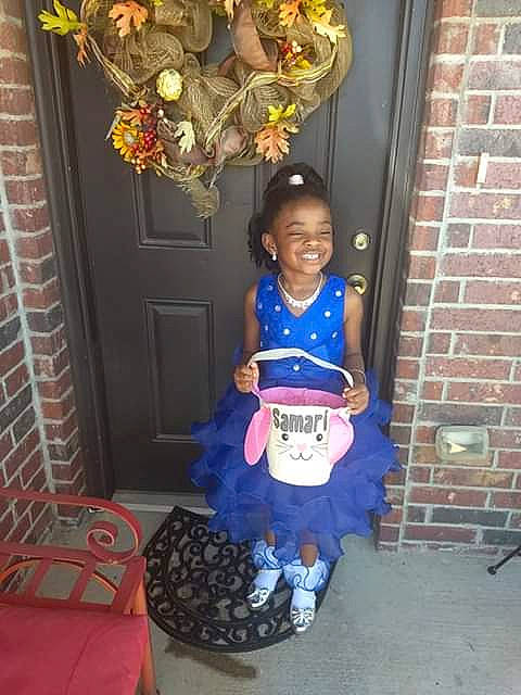 Samari is registered to the contest to win money with this photo: baby, baby_toddler_clothing, brick, brickwork, child, costume, door, dress, electric_blue, event, flooring, fun, jewellery, joy, ornament, person, room, sitting, smile, standing