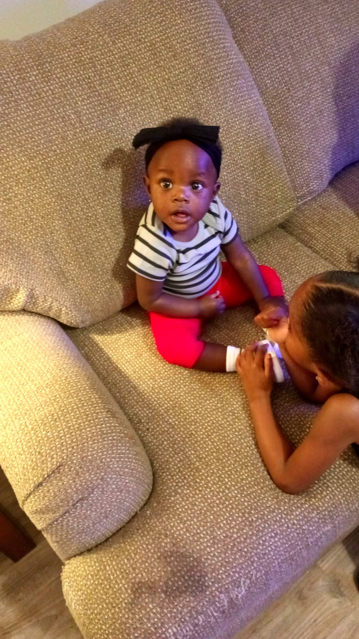 Samira joined the competition — help win amazing prizes! arm, baby_toddler_clothing, comfort, cool, couch, finger, floor, flooring, hand, happy, head, human_leg, leg, linens, magenta, person, skin, sleeve, t_shirt, textile