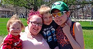 Edward is registered to the contest to win money with this photo: cap, casual_clothing, child, children, daytime, embrace, family, glasses, grass, greenery, happy, outdoor, park, people, portrait, smile, sunglasses, sunny, trees, woman