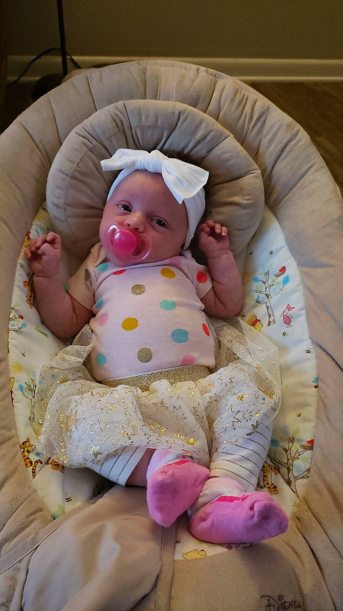 Monica is registered to the contest to win money with this photo: arm, baby, baby_products, baby_sleeping, baby_toddler_clothing, cheek, child, comfort, eye, iris, leg, linens, pattern, person, pink, product, sitting, skin, sleeve, textile