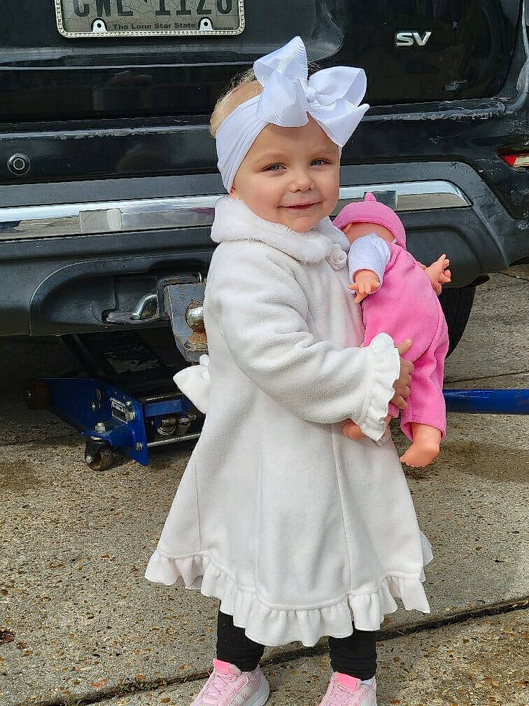 Amelia is registered to the contest to win money with this photo: automotive_exterior, automotive_lighting, automotive_tire, baby_toddler_clothing, bumper, car, child, happy, hat, headwear, joy, motor_vehicle, parking, person, pink, shoe, smile, sneakers, toddler, vehicle