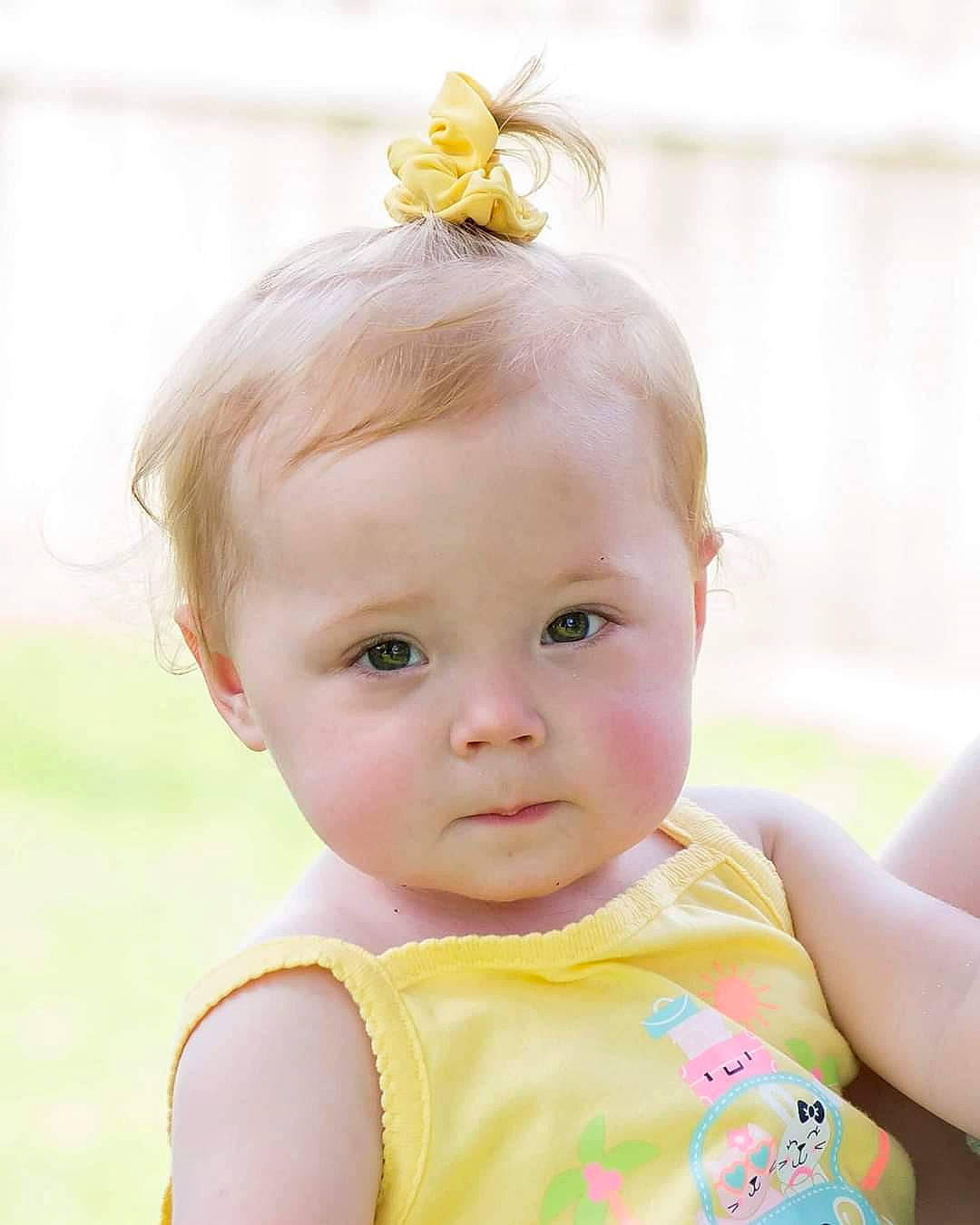 Chloe is registered to the contest to win money with this photo: baby, child, child_model, ear, hair_accessory, head, neck, person, pink, skin, smile, toddler, yellow