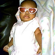Xureila joined the competition — help win amazing prizes! baby, child, infant, sunglasses, heart_shaped_glasses, pink_clothing, white_clothing, lying_down, pillow, blanket, portrait, indoors, face, person, fashion, cute, relaxed, bed, flash_photography, vintage_photo