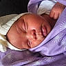 Athena is registered to the contest to win money with this photo: newborn, baby, sleeping, infant, face, portrait, blanket, swaddled, purple, clothing, hand, indoors, cozy, peaceful, resting, close_up, head, soft, nursery, child