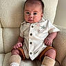 adorable, armchair, baby, child, clothing, collared_shirt, cozy, face, feet, furniture, hands, indoors, infant, portrait, shoes, shorts, sitting, socks, textured_fabric, wide_eyed