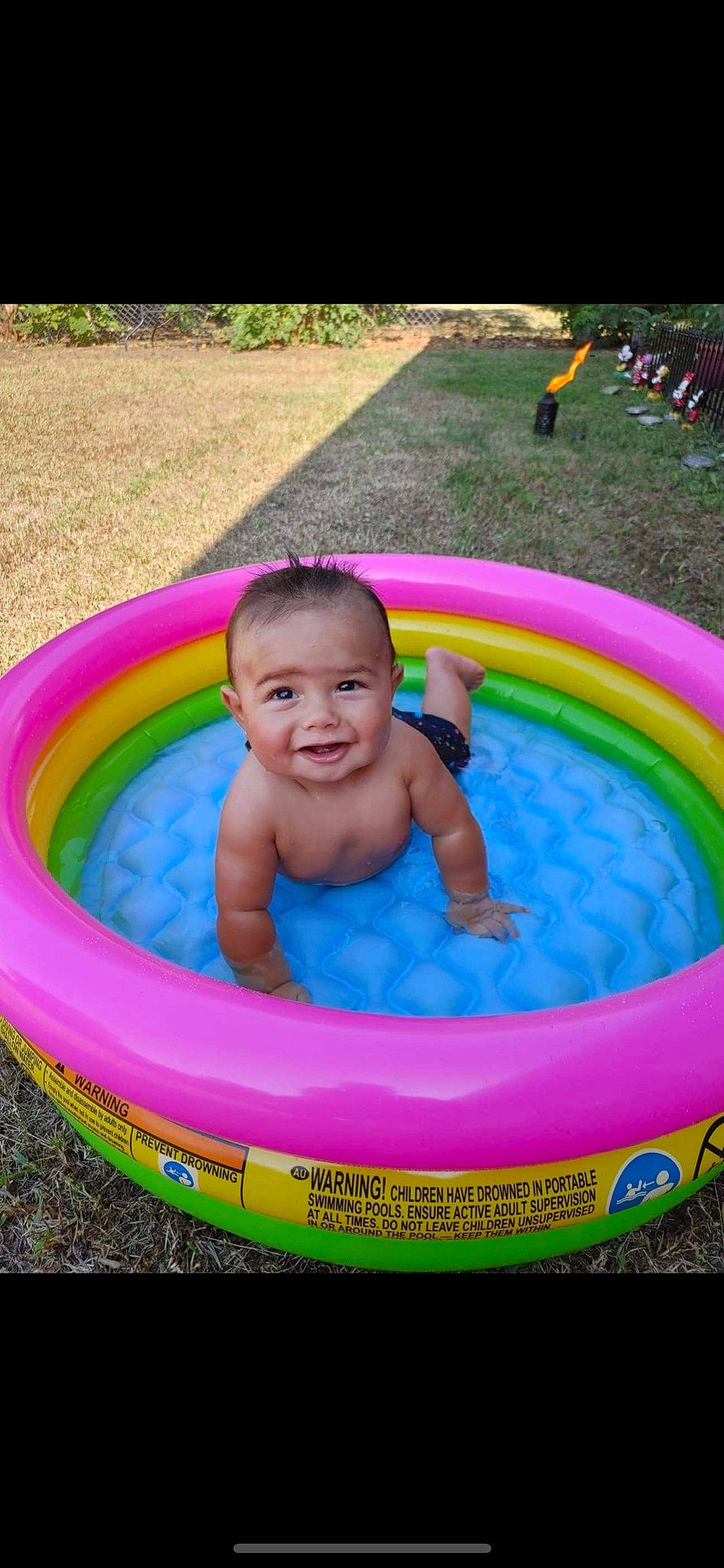 Mateo is registered to the contest to win money with this photo: baby, baby_toddler_clothing, bathing, child, circle, fun, games, grass, green, inflatable, leisure, person, pink, play, recreation, smile, summer, toddler, water