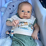 Mayson participe au concours pour gagner de l'argent avec cette photo : baby, infant, face, eyes, clothing, shorts, shirt, toy, teething_toy, baby_carrier, pillow, knitted_pillow, bear_pillow, hand, legs, cozy, cute, indoor, child, portrait