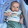 Mayson participe au concours pour gagner de l'argent avec cette photo : baby, baby_carrier, bear_pillow, child, clothing, cozy, cute, eyes, face, hand, indoor, infant, knitted_pillow, legs, pillow, portrait, shirt, shorts, teething_toy, toy