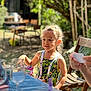 Tissaya participe au concours pour gagner de l'argent avec cette photo : child, outdoor, sunlight, toy, table, chair, greenery, garden, summer, happy, person, casual_clothing, nature, daytime, playing, smiling, people, relaxation, fun, colorful