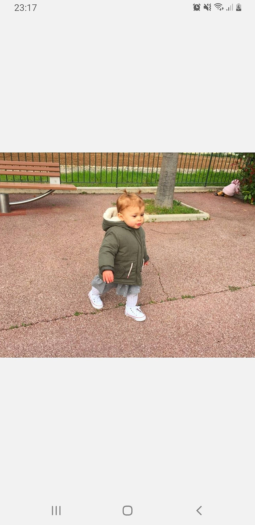 Paola participe au concours pour gagner de l'argent avec cette photo : asphalt, baby, child, clothing, denim, flooring, fun, grass, happy, jacket, leisure, people_in_nature, person, plant, play, recreation, road_surface, sitting, sleeve, soil