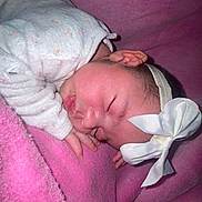 Elyn participe au concours pour gagner de l'argent avec cette photo : baby, sleeping, bow, headband, blanket, pink, pajamas, infant, cozy, cute, closeup, soft, child, newborn, face, hand, peaceful, resting, indoors, portrait