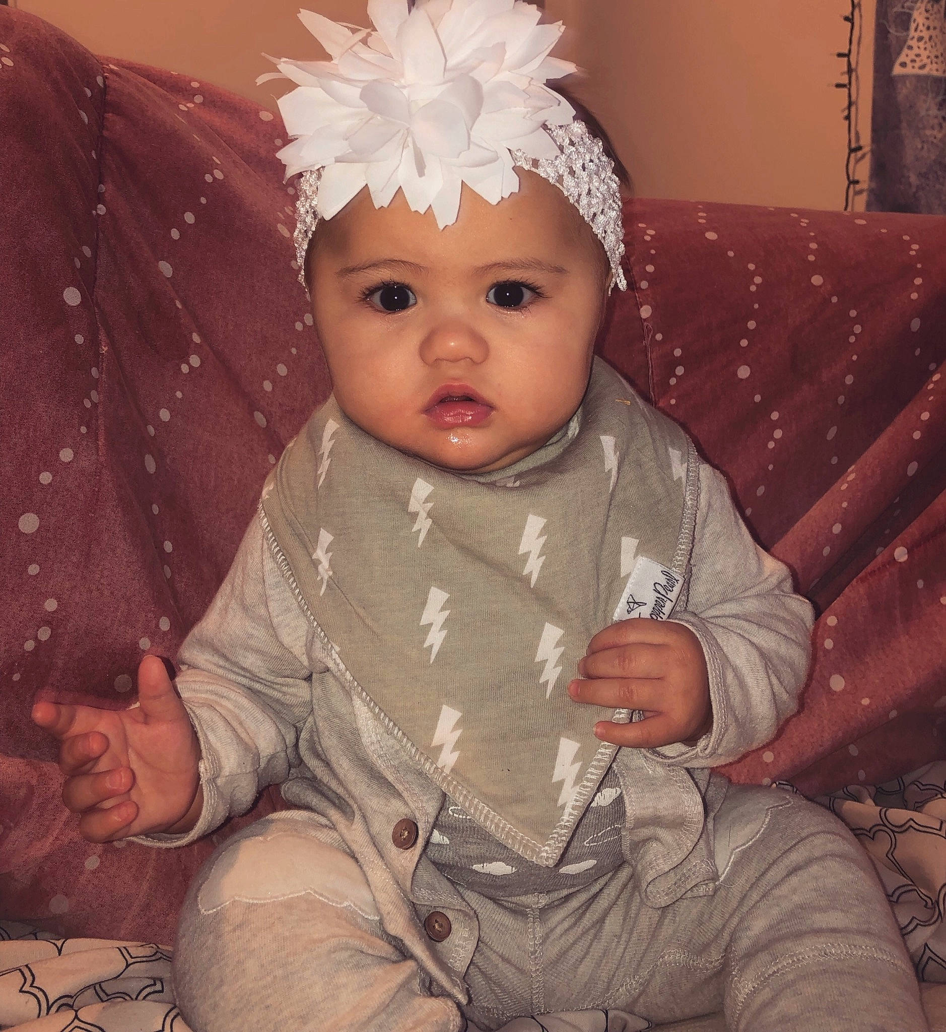 Kiana is registered to the contest to win money with this photo: baby, baby_toddler_clothing, beige, bonnet, cheek, child, eye, face, fashion_accessory, fur, hair_accessory, head, headgear, headpiece, iris, person, product, sitting, skin, smile