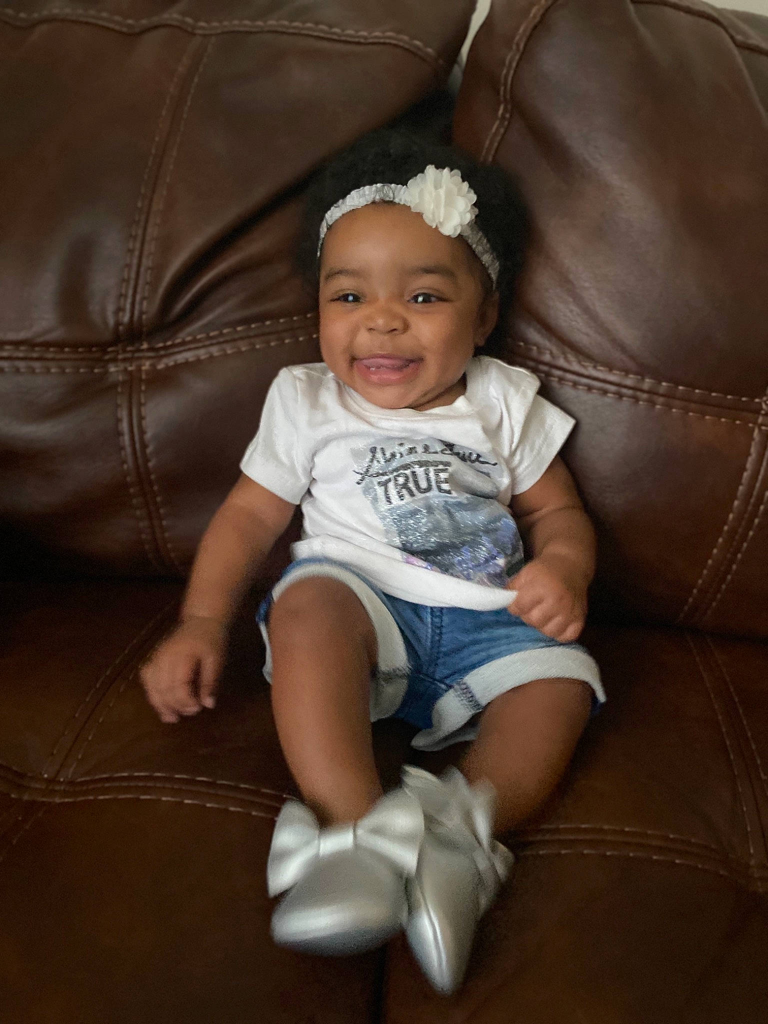 Lyriq is registered to the contest to win money with this photo: baby, cheek, child, family, floor, fun, furniture, headwear, joy, leg, person, shoe, sitting, skin, smile, toddler