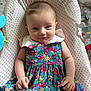 Aurore participe au concours pour gagner de l'argent avec cette photo : baby, child, dress, colorful, pattern, cherry, cushion, star_pattern, toy, smile, face, hand, indoor, cute, infant, clothing, fabric, comfort, portrait, playful