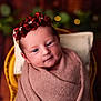 newborn, baby, infant, wrapped, blanket, headband, flowers, gems, cushion, basket, portrait, closeup, soft_light, indoors, cute, sleepy, face, peaceful, warm_colors, decorative
