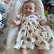 Aurore participe au concours pour gagner de l'argent avec cette photo : baby, infant, smile, dress, teddy_bear_pattern, baby_seat, toy, colorful, cute, child, comfort, playful, soft_toy, indoors, cushion, happy, person, young_child, reclining, clothing