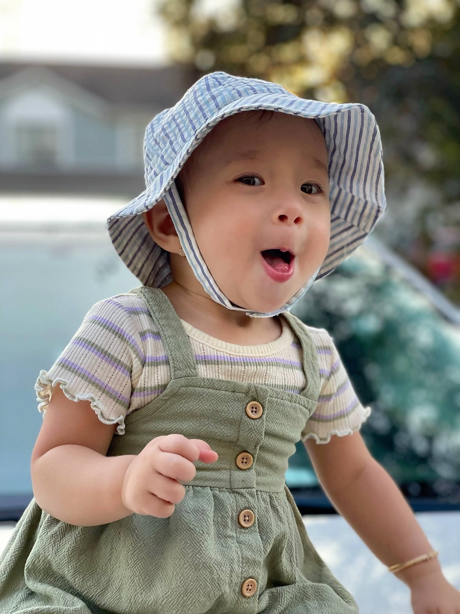 Theresa is registered to the contest to win money with this photo: baby, baby_toddler_clothing, cap, cheek, child, cool, eye, fun, grass, happy, headgear, headwear, human_body, lip, outerwear, pattern, person, skin, sleeve, smile