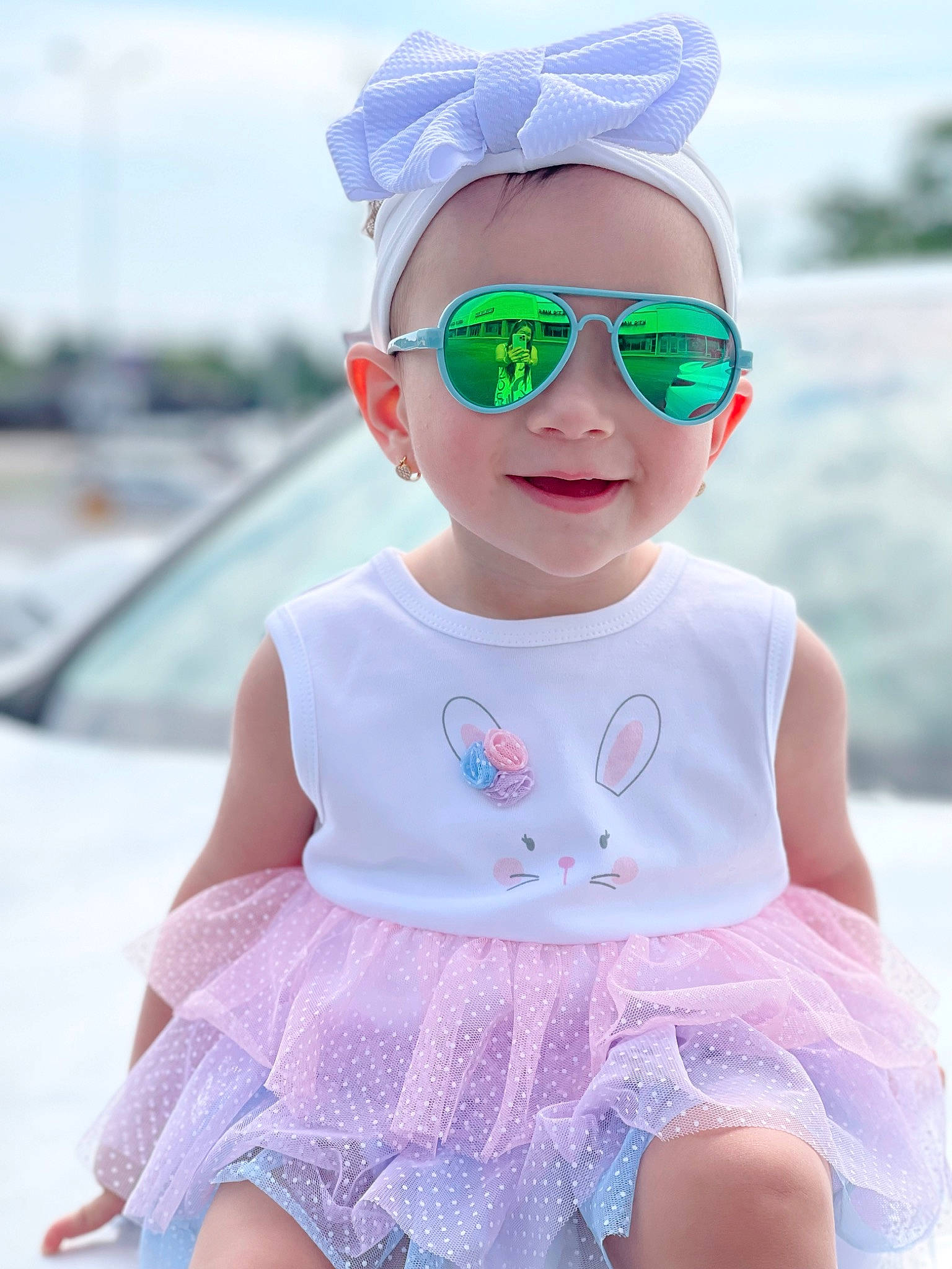 Theresa is registered to the contest to win money with this photo: aqua, baby_toddler_clothing, blue, cap, clothing, dress, eyewear, face, glasses, goggles, happy, hat, headgear, person, photograph, pink, sky, sleeve, sunglasses, vision_care