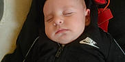 Lewis participe au concours pour gagner de l'argent avec cette photo : baby, sleeping, hoodie, black_clothing, nike_logo, infant, pillow, resting, peaceful, indoor, child, young_child, face, person, cute, calm, comfort, soft, portrait, closeup