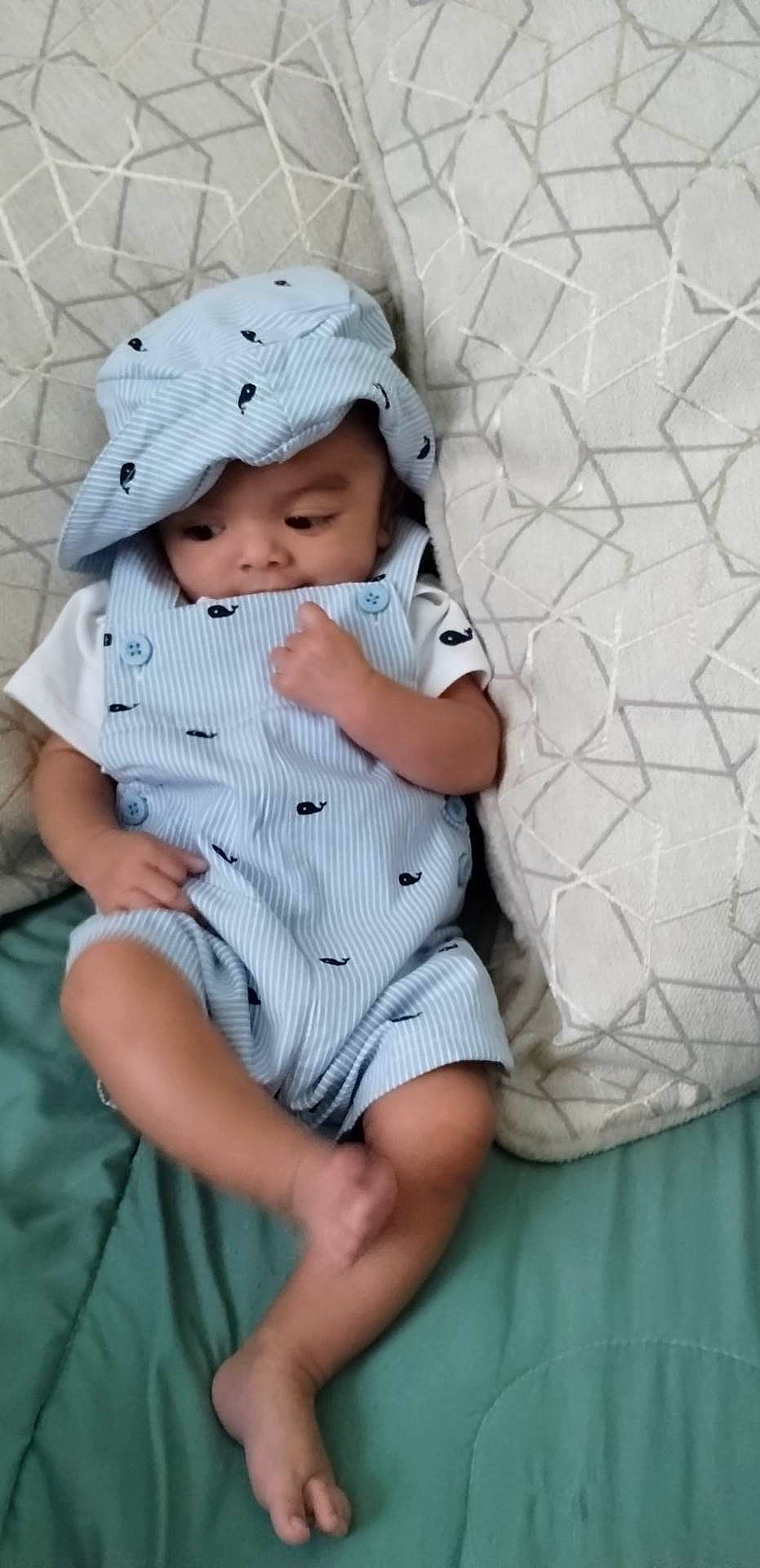 Cyrus joined the competition — help win amazing prizes! baby, baby_toddler_clothing, cap, child, collar, comfort, dress, fashion_accessory, grass, hat, headwear, human_leg, linens, pattern, person, sitting, skin, sleeve, sun_hat, textile