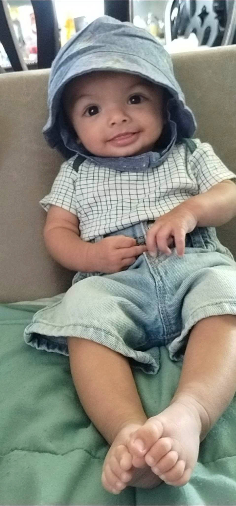 Cyrus joined the competition — help win amazing prizes! baby, baby_toddler_clothing, cap, cheek, child, comfort, fashion_accessory, grass, headwear, human_leg, knee, leg, lip, pattern, person, sitting, skin, sleeve, smile, sock