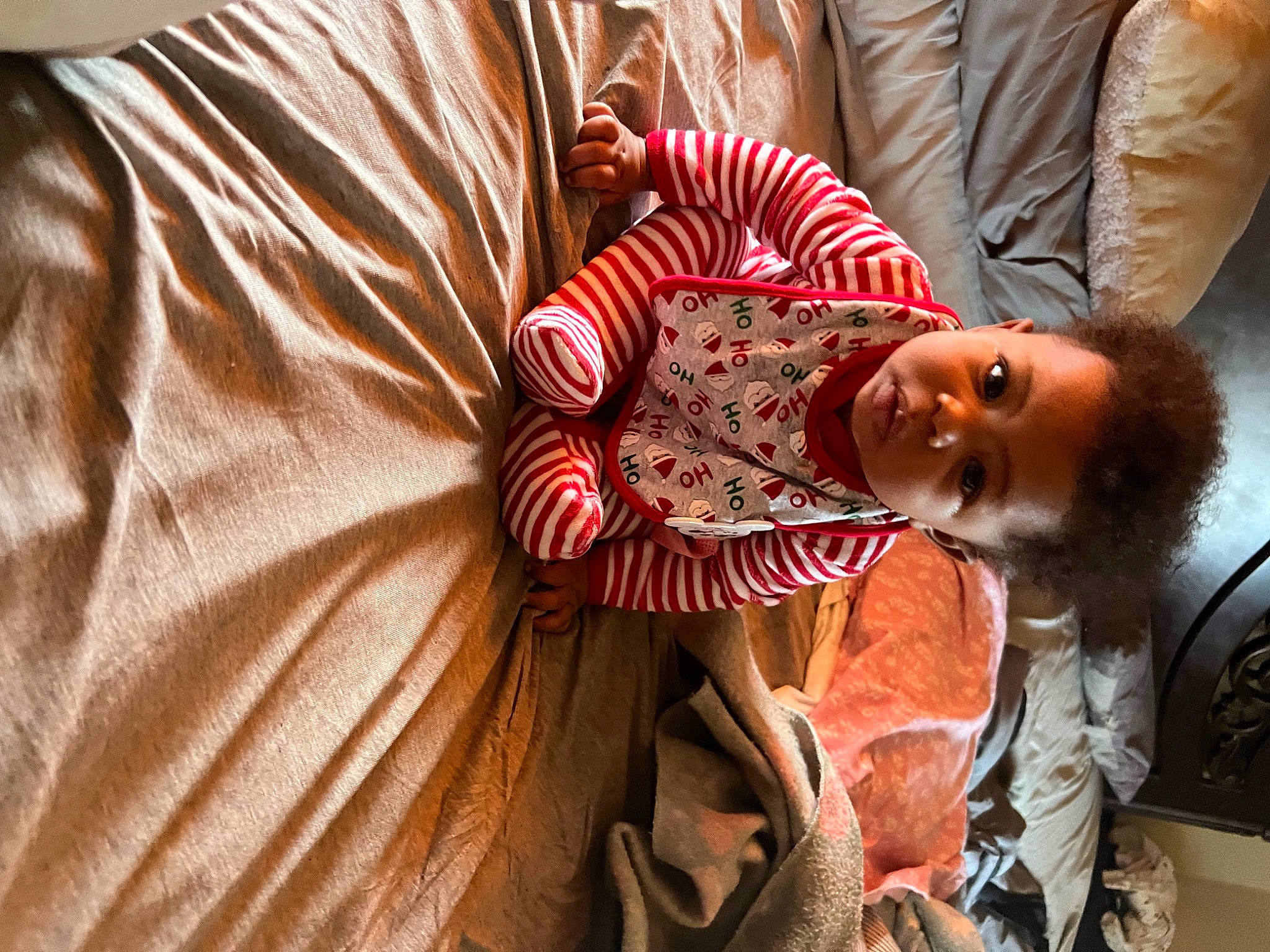 Armani is registered to the contest to win money with this photo: baby, child, comfort, couch, event, fashion_design, flesh, fun, fur, happy, hat, linens, orange, pattern, person, room, textile, toddler, toy, tradition