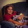 child, girl, kitten, cat, blanket, armchair, smile, indoors, cozy, cuddling, comfort, furniture, young, pet, happy, casual_clothing, relaxing, home, portrait, warm_lighting