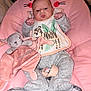 baby, infant, pink, plush_toy, bunny, bib, gray_clothing, cute_face, indoor, seat, soft_toy, child, newborn, cozy, cute, pouty_face, comfort, animal_print, resting, adorable