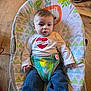 Emmett is registered to the contest to win money with this photo: baby, bouncer, child, clothing, colorful, expression, face, footwear, furniture, hands, heart, indoor, infant, jeans, mom, patterned, person, seated, shirt, wooden_floor