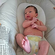 Emmett is registered to the contest to win money with this photo: baby, newborn, diaper, infant, bassinet, white, sleeping_bed, feet, hand, skin, cute, resting, child, person, indoors, soft, comfort, closeup, portrait, relaxing