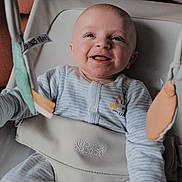 Patrick is registered to the contest to win money with this photo: baby, smiling, infant, onesie, baby_seat, toy, hanging_toy, giraffe_design, happy, cute, child, indoor, soft_light, closeup, face, person, seatbelt, comfort, young_child, playful