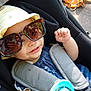 Inaya participe au concours pour gagner de l'argent avec cette photo : baby, blue_clothing, car_seat, child, childhood, cute, face, hand, hat, infant, outdoor, playful, portrait, safety, seatbelt, smile, sunglasses, sunhat, sunlight, toy